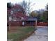 Brick home exterior featuring a vibrant tree, well-manicured lawn, and concrete driveway at 1217 Dove Ct, Morrow, GA 30260