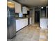 Spacious kitchen featuring white cabinets, tile flooring, and stainless steel refrigerator at 1217 Dove Ct, Morrow, GA 30260