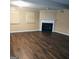Spacious living room featuring dark wood laminate flooring and a cozy fireplace at 1217 Dove Ct, Morrow, GA 30260
