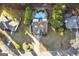 Aerial view of a home with a pool, backyard patio, mature trees, and driveway at 119 Brookgrove Ln, Peachtree City, GA 30269