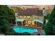 Aerial view of this property's large backyard with an in-ground pool, outdoor kitchen and screened-in porch at 119 Brookgrove Ln, Peachtree City, GA 30269