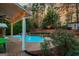 Expansive backyard featuring a pool, covered patio, and meticulously landscaped garden at 119 Brookgrove Ln, Peachtree City, GA 30269