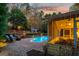 Charming backyard view with a pool, screened porch, and stone retaining wall at 119 Brookgrove Ln, Peachtree City, GA 30269