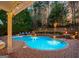 Beautiful backyard showcasing the pool, brick patio, and lush greenery at 119 Brookgrove Ln, Peachtree City, GA 30269