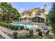 Large backyard showcasing a pool, spa, outdoor kitchen, screened-in porch, and patio with manicured landscaping at 119 Brookgrove Ln, Peachtree City, GA 30269