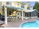 Outdoor kitchen and screened in porch beside an in-ground pool with brick patio at this backyard oasis at 119 Brookgrove Ln, Peachtree City, GA 30269