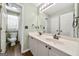 Bathroom featuring double sinks, white cabinets, and a walk in shower at 119 Brookgrove Ln, Peachtree City, GA 30269
