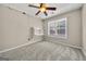 Bright bedroom featuring neutral walls, built in shelving, neutral carpet, and a ceiling fan at 119 Brookgrove Ln, Peachtree City, GA 30269