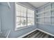 Walk-in closet with adjustable shelving, gray wood floor, and window providing natural light at 119 Brookgrove Ln, Peachtree City, GA 30269