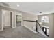 Upstairs hallway with carpet and decorative window overlooking the front yard at 119 Brookgrove Ln, Peachtree City, GA 30269