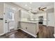 Well-lit kitchen featuring white cabinets, granite countertops, stainless steel appliances and dark hardwood floors at 119 Brookgrove Ln, Peachtree City, GA 30269