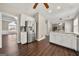 Open kitchen layout with granite countertops, stainless steel refrigerator and hardwood floors at 119 Brookgrove Ln, Peachtree City, GA 30269