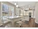Bright kitchen island with granite countertops and white barstools, flooded with natural light at 119 Brookgrove Ln, Peachtree City, GA 30269