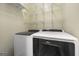 Laundry room with a modern white washer and dryer at 119 Brookgrove Ln, Peachtree City, GA 30269