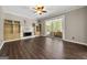 Spacious living room featuring modern flooring, a fireplace, built-in shelving, and access to a screened porch at 119 Brookgrove Ln, Peachtree City, GA 30269