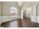 Open floor plan with large windows, hardwood flooring, and tasteful neutral wall colors at 119 Brookgrove Ln, Peachtree City, GA 30269