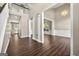 Open-concept living room with hardwood floors, wainscoting, and elegant chandelier lighting at 119 Brookgrove Ln, Peachtree City, GA 30269