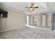 Spacious main bedroom featuring plush carpet, neutral paint, and access to an ensuite bathroom at 119 Brookgrove Ln, Peachtree City, GA 30269
