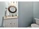 Stylish powder room features granite countertop, decorative mirror, and vanity at 119 Brookgrove Ln, Peachtree City, GA 30269
