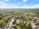 The aerial view captures the neighborhood nestled amongst lush greenery near the winding river at 735 River Ridge Ln, Suwanee, GA 30024