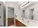 Bright double vanity bathroom with a large mirror and a view into the connected bedroom at 735 River Ridge Ln, Suwanee, GA 30024