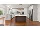 Spacious kitchen with white cabinets, stainless steel appliances, hardwood floors, and large island at 735 River Ridge Ln, Suwanee, GA 30024