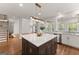Spacious kitchen with a large island, hardwood floors, stainless steel appliances, and stylish light fixtures at 735 River Ridge Ln, Suwanee, GA 30024