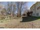 The backyard features mature trees, a swing set, and views of the multi-story home at 2032 Stonewick Ct, Lawrenceville, GA 30043