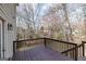 A wooden deck with railings offers an outdoor space with views of the surrounding trees at 2032 Stonewick Ct, Lawrenceville, GA 30043