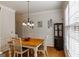Cozy dining room with hardwood floors, crown molding, and bright window at 2032 Stonewick Ct, Lawrenceville, GA 30043