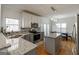 Bright kitchen with white cabinets, granite countertops, stainless appliances, and hardwood floors at 2032 Stonewick Ct, Lawrenceville, GA 30043