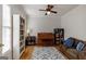 Comfortable living room with hardwood floors, a piano, and a cozy seating area with natural light at 2032 Stonewick Ct, Lawrenceville, GA 30043