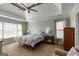 Bright main bedroom with tray ceiling, ceiling fan, and natural light at 2032 Stonewick Ct, Lawrenceville, GA 30043