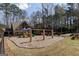 Community playground featuring swings and slides on a bed of mulch at 2032 Stonewick Ct, Lawrenceville, GA 30043