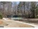 Fully fenced sport court, perfect for basketball or tennis, with ample space for spectators at 2032 Stonewick Ct, Lawrenceville, GA 30043