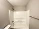 Bathroom shower/tub combination with white tile surround and modern fixtures at 173 Regency Park Dr, Mcdonough, GA 30253