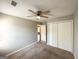 Bedroom with closet featuring neutral paint, ceiling fan, brown carpet, and natural light at 173 Regency Park Dr, Mcdonough, GA 30253