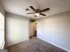 Bedroom with closet featuring neutral paint, ceiling fan, brown carpet, and natural light at 173 Regency Park Dr, Mcdonough, GA 30253