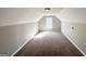 Spacious bonus room featuring neutral paint, sloped ceilings, and a window at 173 Regency Park Dr, Mcdonough, GA 30253