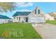 Charming single-Gathering home featuring a well-manicured lawn, neutral siding, and an attached two-car garage at 173 Regency Park Dr, Mcdonough, GA 30253