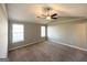 Bright main bedroom featuring new carpet, a ceiling fan, and two large windows at 173 Regency Park Dr, Mcdonough, GA 30253