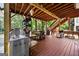 A partially covered porch with red floors and exposed structural beams with an open view at 1721 Telfair Chase Way, Lawrenceville, GA 30043