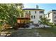 Well-maintained backyard featuring a deck, patio, mature trees, and lush green grass at 1721 Telfair Chase Way, Lawrenceville, GA 30043