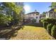 Expansive backyard features a deck, patio, mature trees, and a lush lawn at 1721 Telfair Chase Way, Lawrenceville, GA 30043