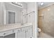Bathroom featuring a tiled shower and bright lighting at 1721 Telfair Chase Way, Lawrenceville, GA 30043