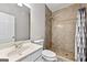 Bathroom featuring a tile shower, framed mirror, and neutral fixtures at 1721 Telfair Chase Way, Lawrenceville, GA 30043