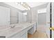 Bathroom features double sink vanity with white cabinets and a large mirror at 1721 Telfair Chase Way, Lawrenceville, GA 30043