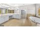 Large primary bathroom features a soaking tub and a double sink vanity with mirrors at 1721 Telfair Chase Way, Lawrenceville, GA 30043