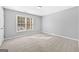 Comfortable bedroom with carpet and a bright sunny window at 1721 Telfair Chase Way, Lawrenceville, GA 30043