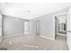 Bright, spacious bedroom with neutral carpet and paint provides a calming atmosphere at 1721 Telfair Chase Way, Lawrenceville, GA 30043